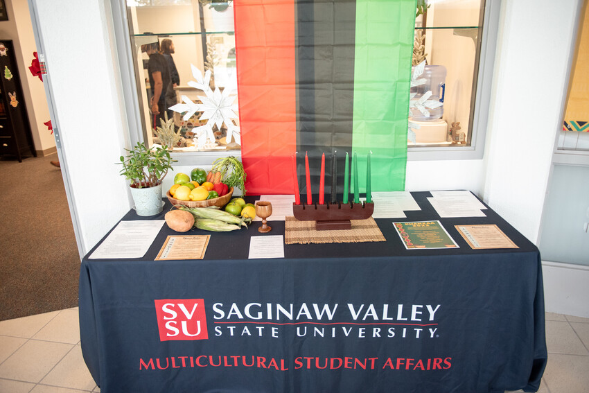A close up of a desk with information about Kwanza